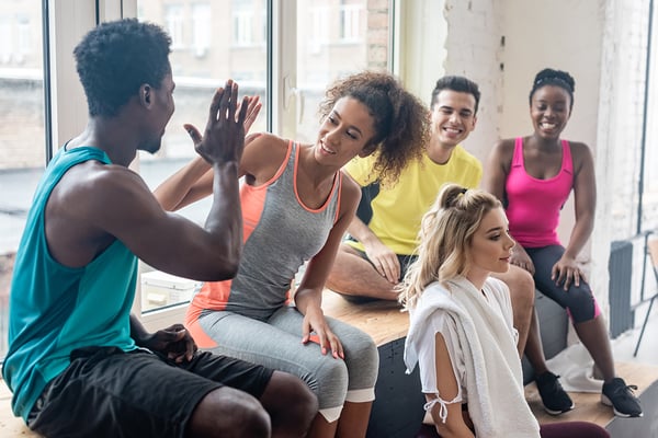 group fitness partcipants high fiving