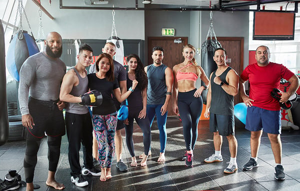 a class of group fitness participants posing