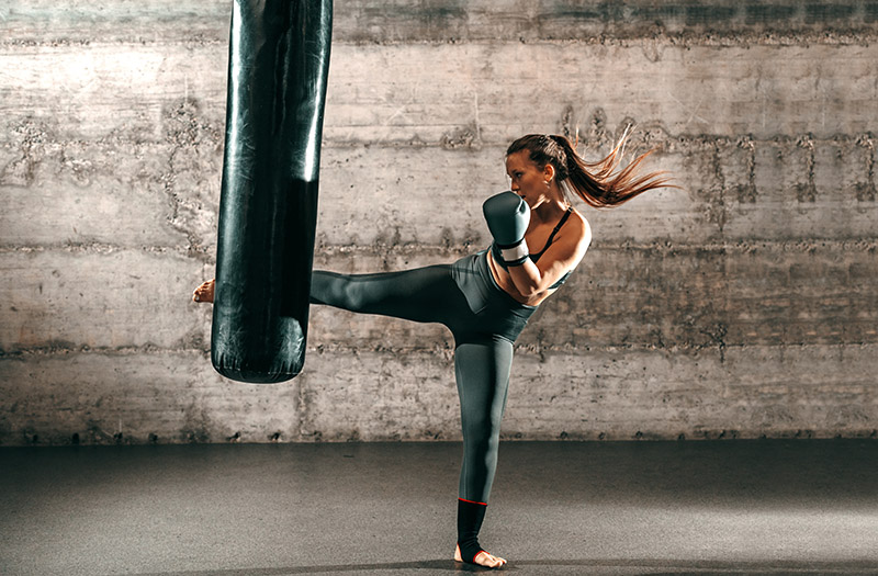 cardio kickboxer doing drills on a punching bag